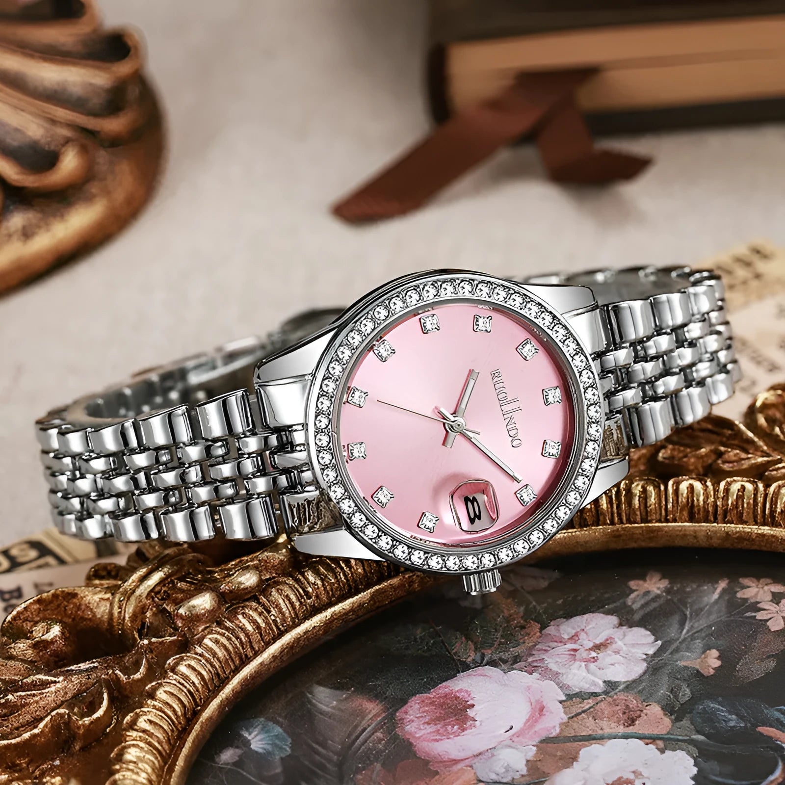 Women's silver alloy quartz calendar watch with round dial and stainless steel folding buckle.