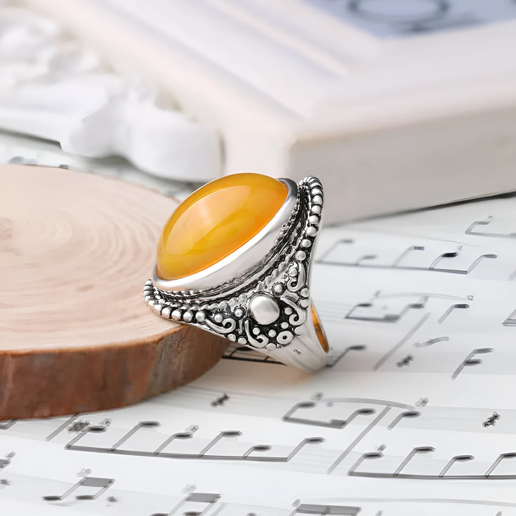 Geometric antique silver amber alloy ring with retro design on a hand.