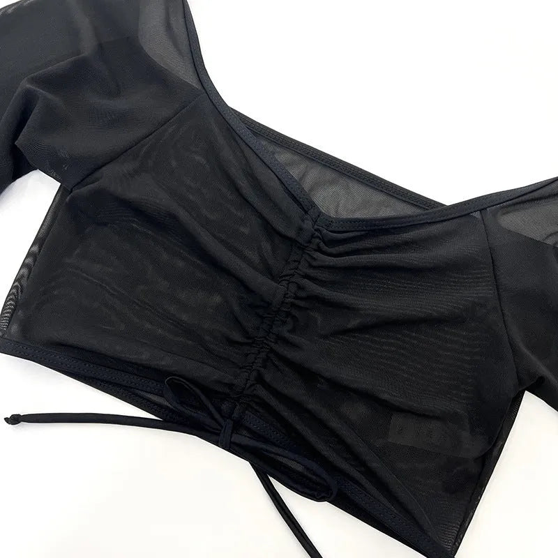 Women's black mesh four-piece bikini set with long sleeves and briefs bottom