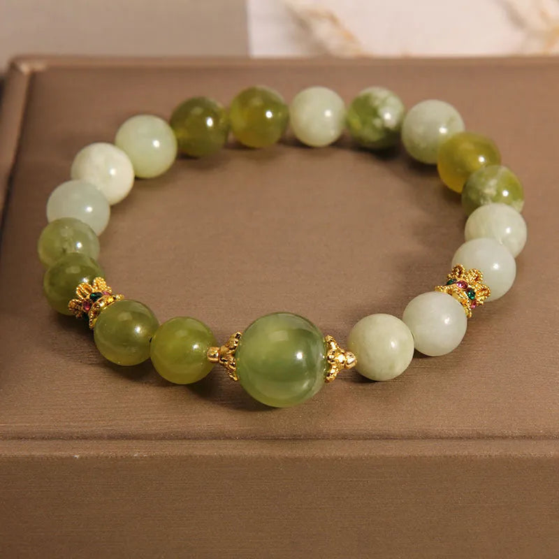 Women's bangle bracelet made from green Xiuyan jade stone with an original design.