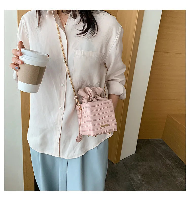 Women's small one shoulder messenger bag with chain strap in bucket style design