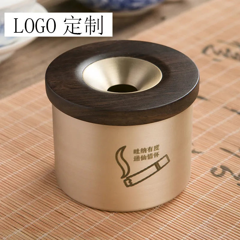 Retro-style brass ashtray with a wooden lid, shown in a home living room setting.
