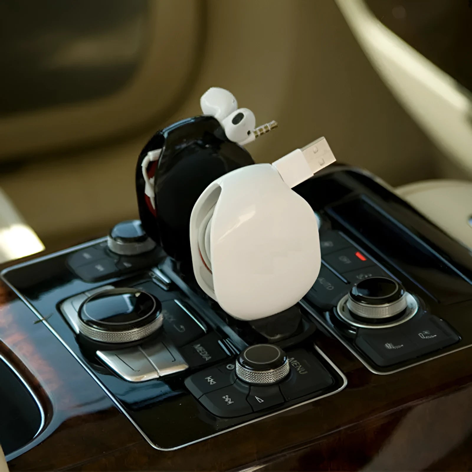 Automatic push-button earphone cable winder reel in assorted colours on a white background.