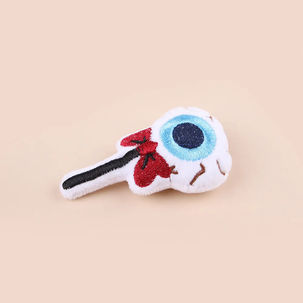 Colourful plush cat tease stick with candy, eyes and skull designs on small wand toy