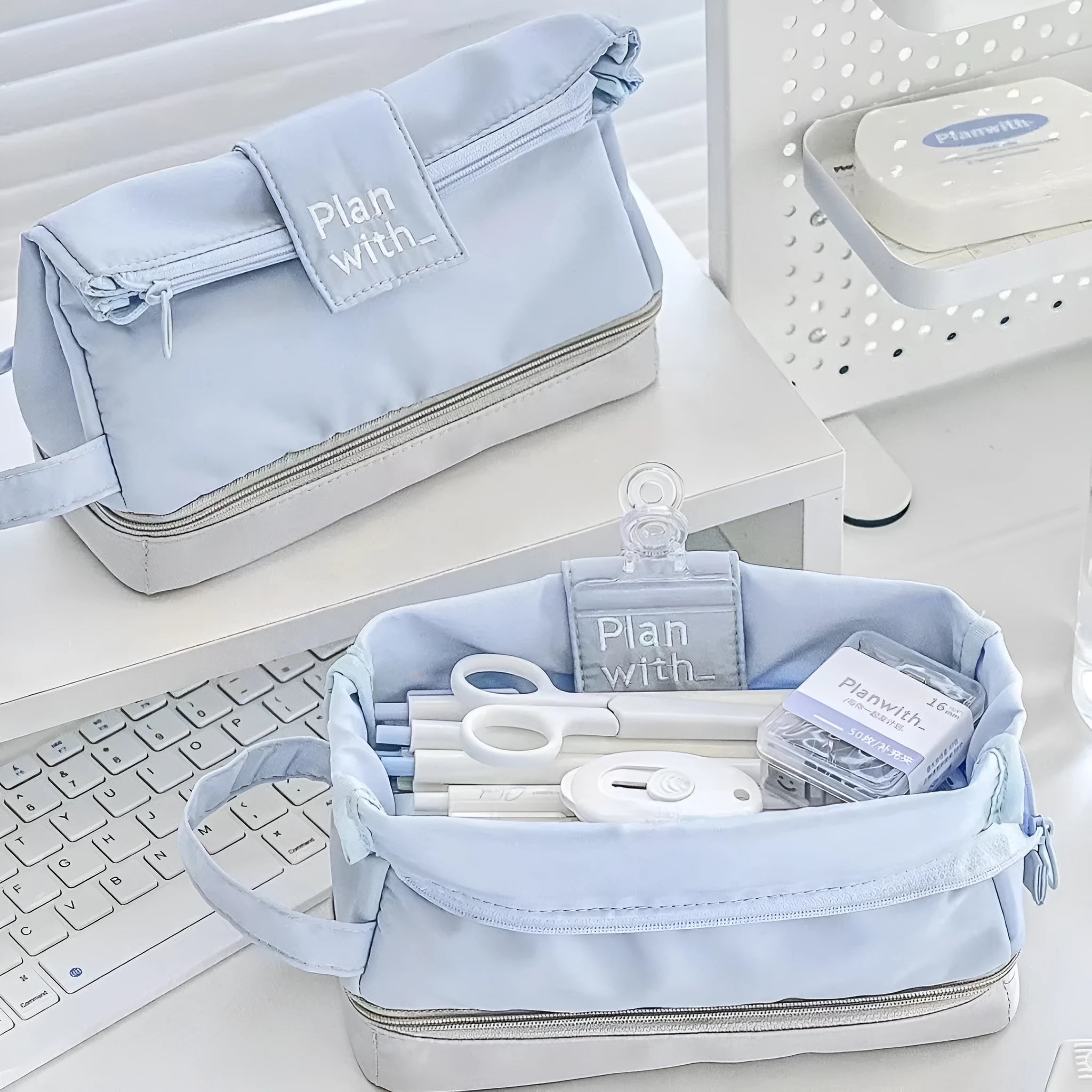 Folding double-layer polyester pencil case in dark blue, blue, and cream white colours with organised compartments