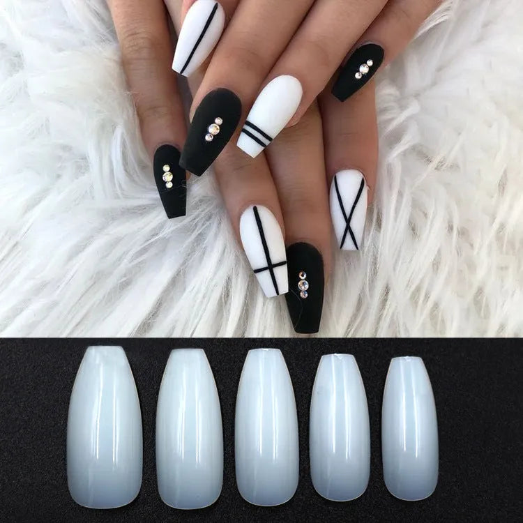 500 clear acrylic false nails in assorted sizes arranged next to application brush and bottle.