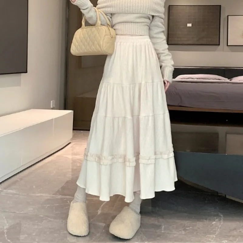 Women's solid colour corduroy A-line midi skirt with an elastic waistband shown in beige.