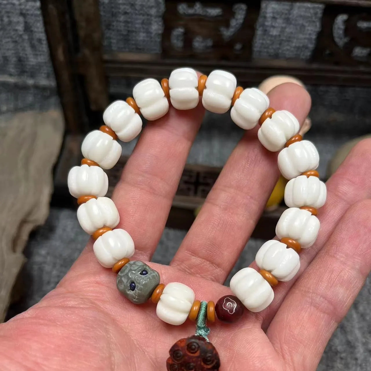 Carved pumpkin lotus bodhi root bracelet with white jade segments and golden silk jade treasures