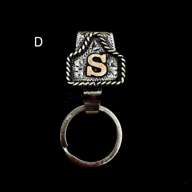 Handmade metal cow tag belt key holder keychain on a key ring, showing the metal loop and tag design.