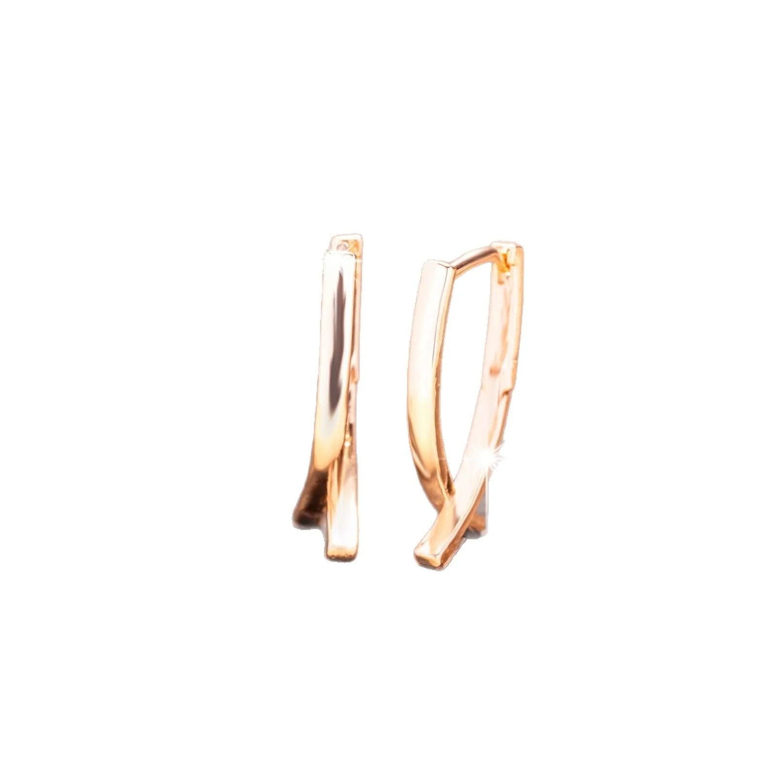 A pair of rose gold coloured cross-shaped earrings on a white background.