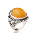 Geometric antique silver amber alloy ring with retro design on a hand.