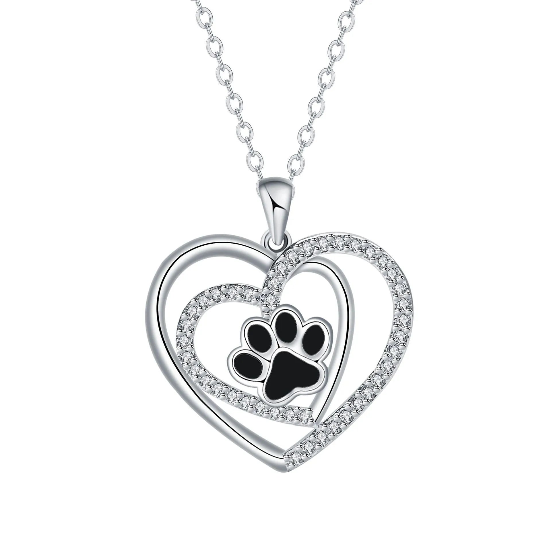 Close-up of a women's heart-shaped copper necklace with a detailed dog paw print pendant on a cross chain.