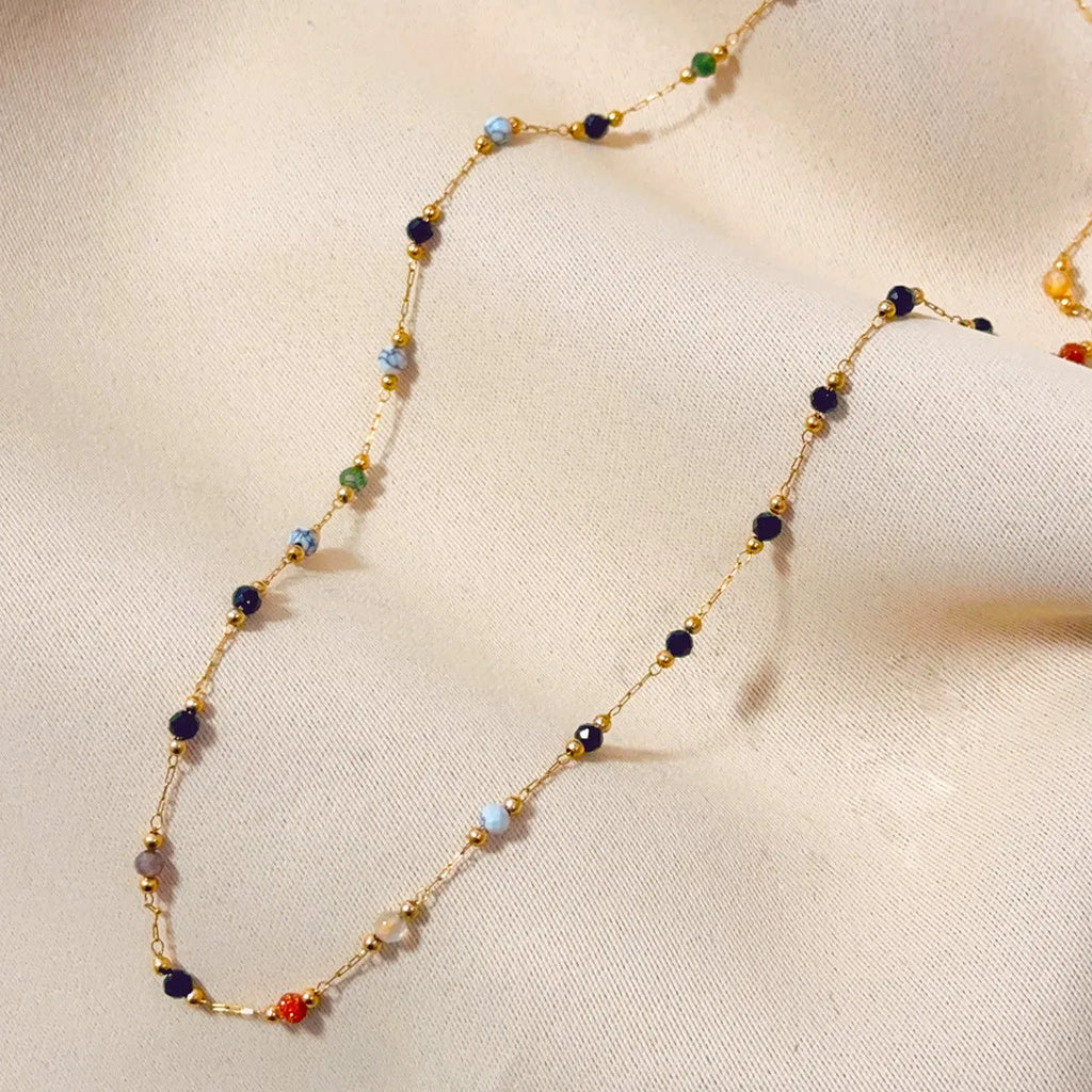 Gold titanium steel necklace with natural stone pendant on female model
