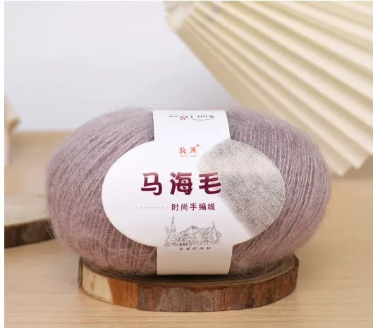 DIY mohair scarf weaving kit showing one wool ball and a selection of 34 colour options including white, pink, blue and green.