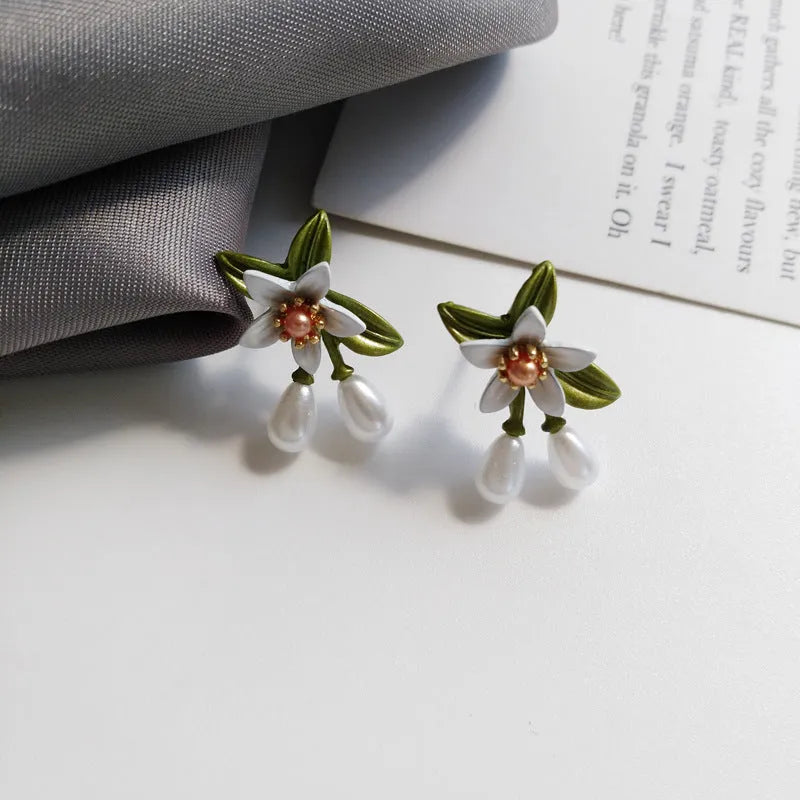 Women's alloy flower earrings with sterling silver needle design and clip-on alternative