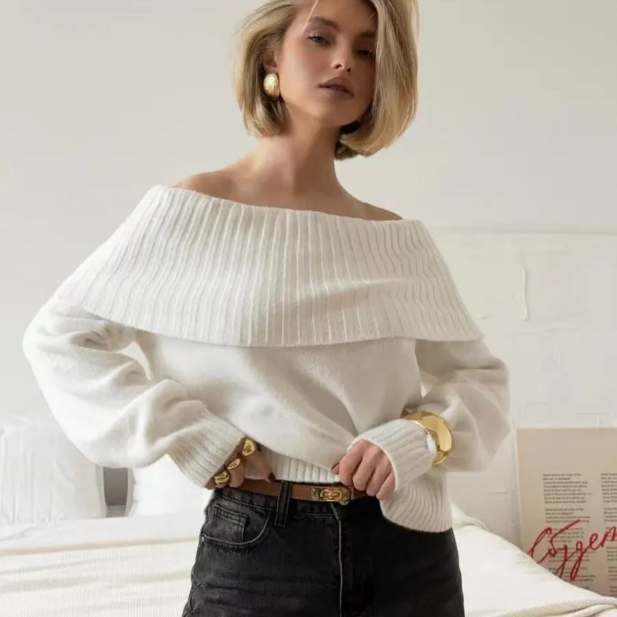 Grey off-the-shoulder sweater with a 3D textured pattern and strapless design.