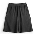 Men's cement grey straight-leg sports shorts with a loose fit, shown on a model.