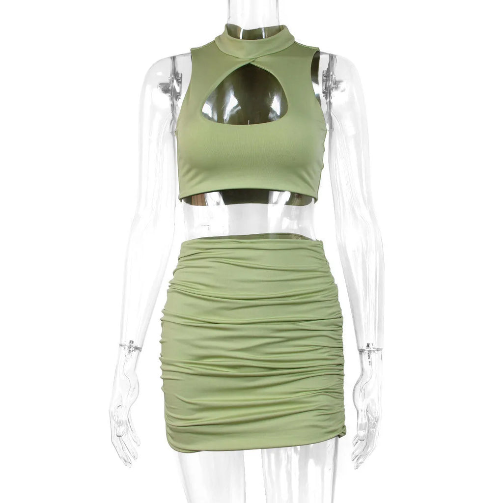 Light purple women's two-piece set with hollow-out vest top and split skirt on a model.