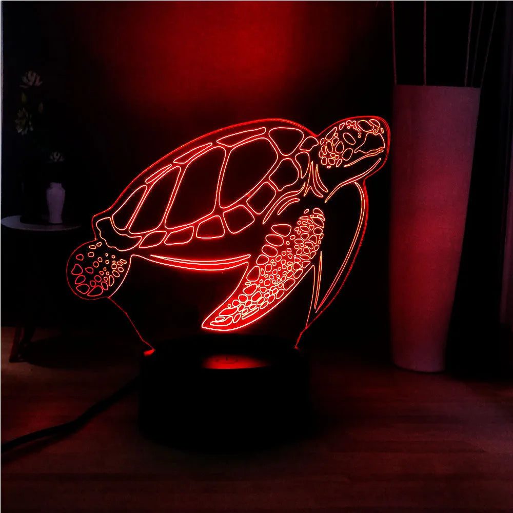 Clear acrylic 3D turtle-shaped LED night light showing multiple colour options on a dark surface.