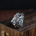 Silver open ring with detailed Jibeast zodiac animal pattern, shown on a hand.
