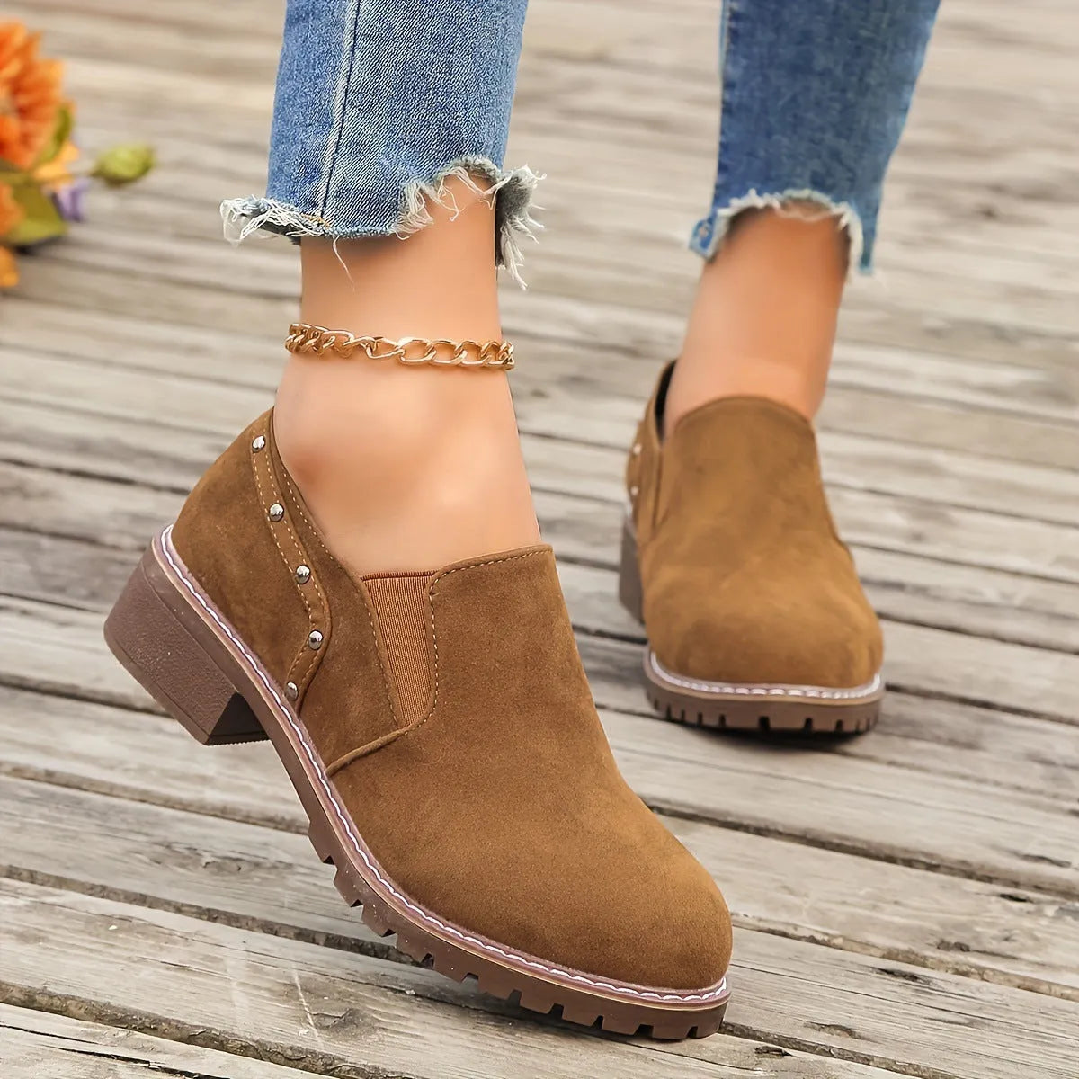 Women's light brown suede ankle boots with a low stout heel and elastic band at the ankle.