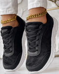 Women's white canvas casual sports running shoe with round toe and flat heel on a neutral background.