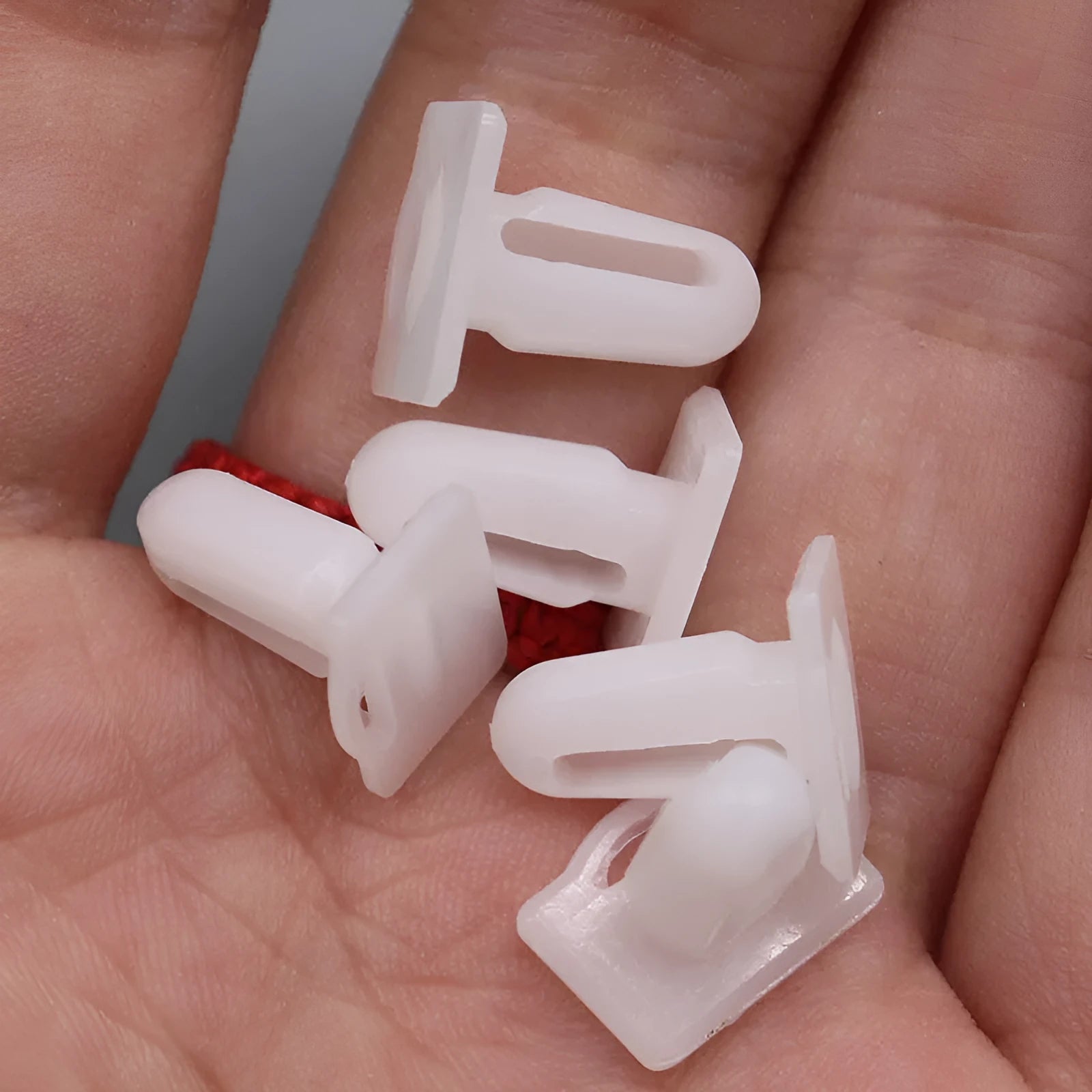 Pack of 60 D318 style grey PA66 plastic automotive glue nails and buckles for trim fastening.
