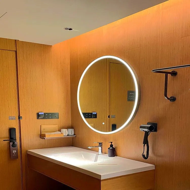 Round black aluminium frame LED smart bathroom mirror mounted on wall with illuminated surface.