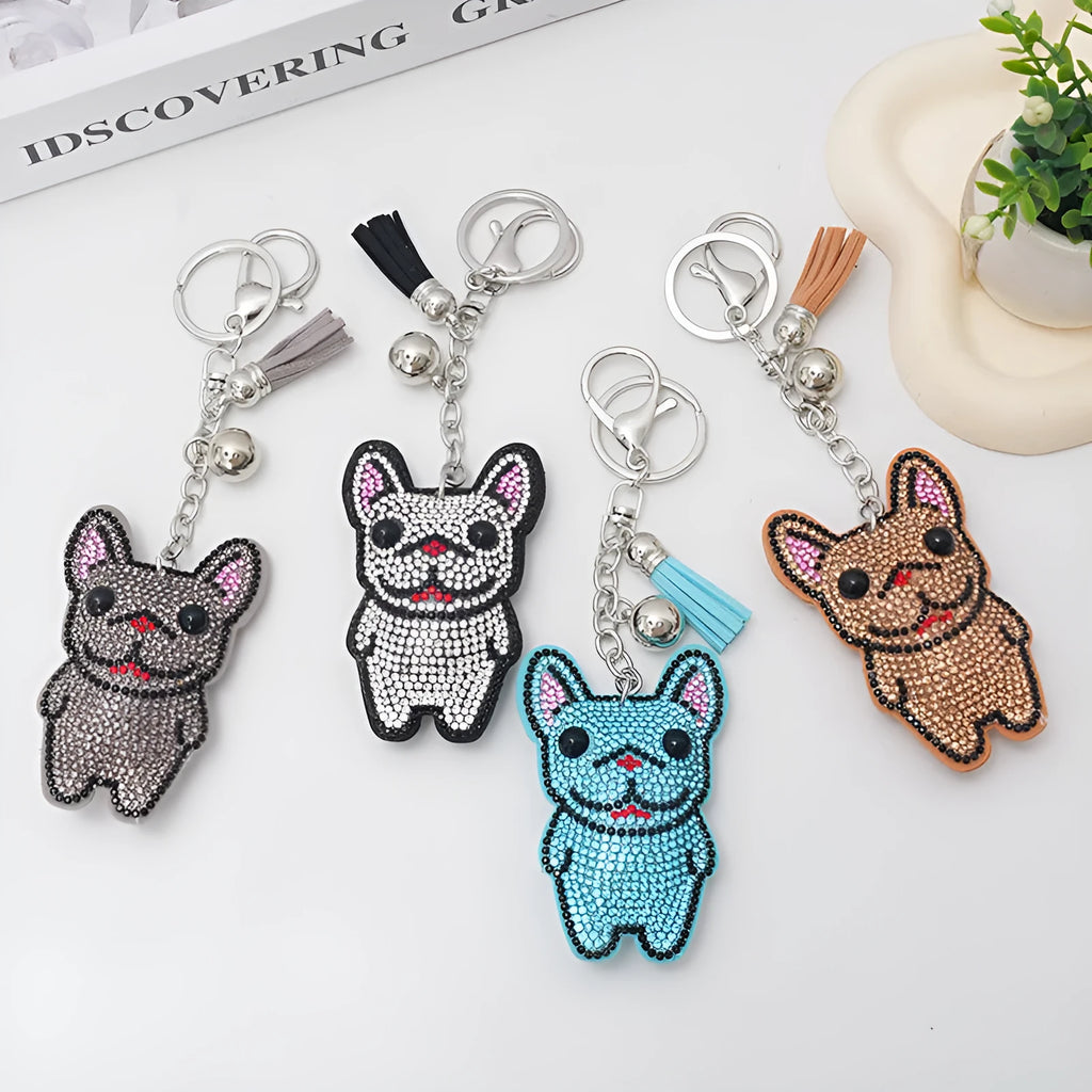 Close-up of a rhinestone dog charm keychain in a caramel colour with sparkling stones on a metal base.
