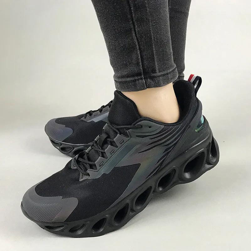 A pair of black low-top casual sports shoes with mesh upper and lace-up front.