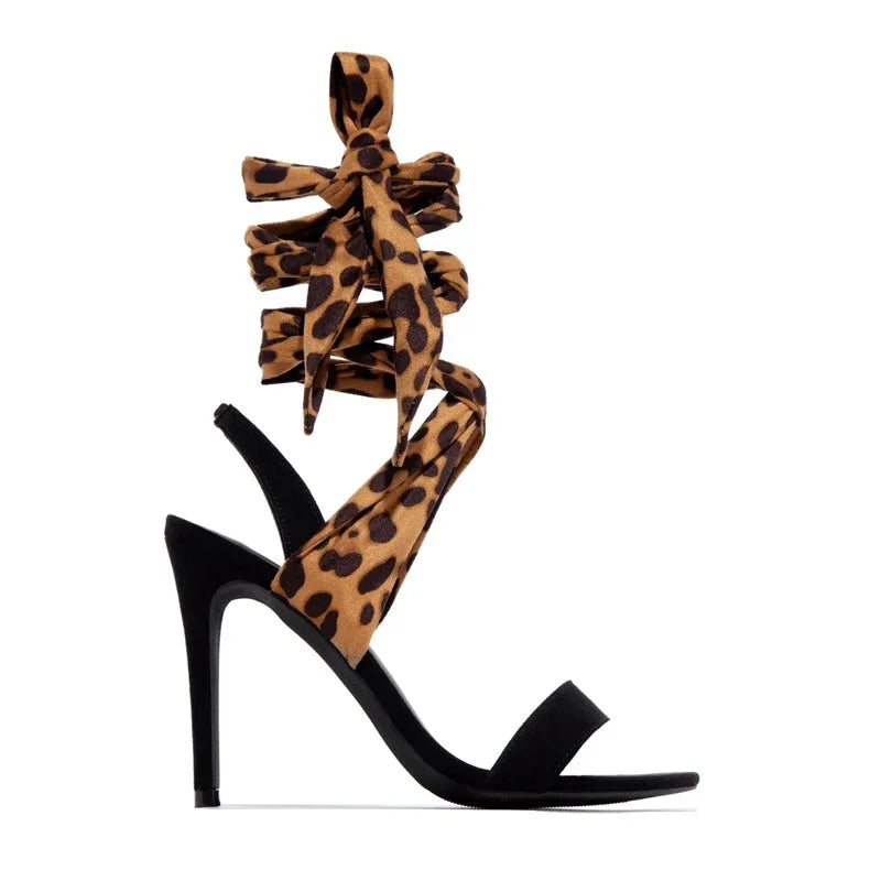 Light brown leopard print Roman style high heels with cross strap and thin 8cm heel.