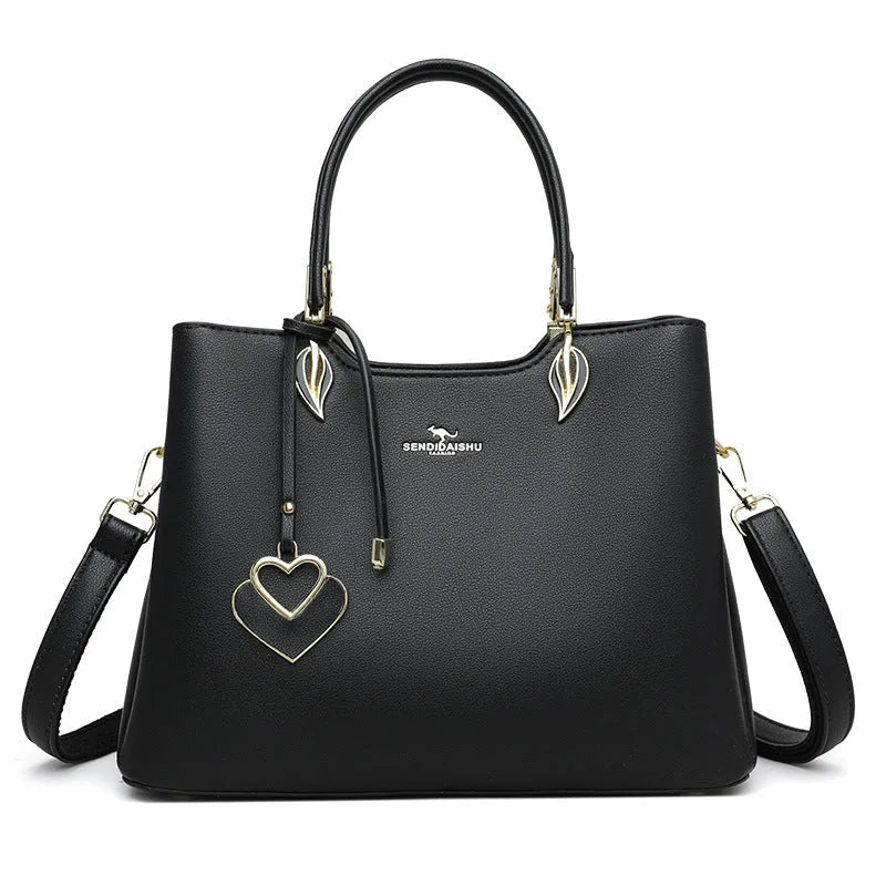 Women's black PU messenger bag with multi-layer design and visible sewing thread detail.