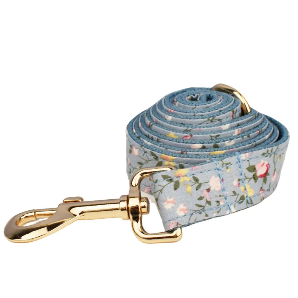 Blue floral pattern dog collar set with matching accessories including bow, leash and vest