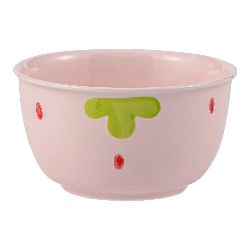 Porcelain dinnerware set with strawberry design showing plates, flower bowls, and twist spoon