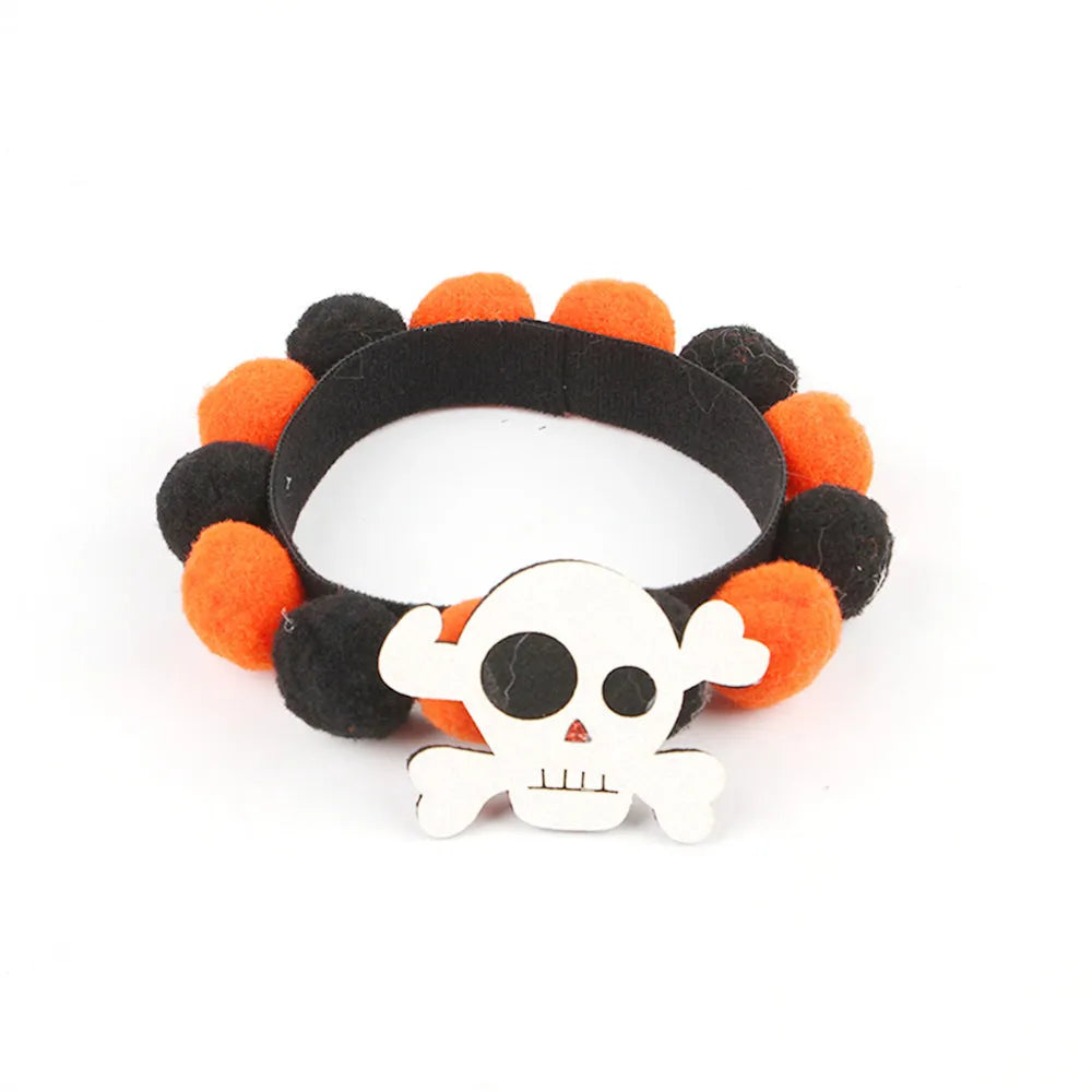 Halloween dog collar with a large orange pom-pom and pumpkin design on an adjustable black band.