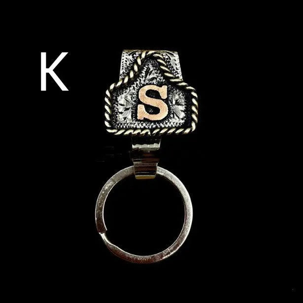 Handmade metal cow tag belt key holder keychain on a key ring, showing the metal loop and tag design.