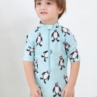 Boys' penguin print long sleeve one-piece swimsuit with matching swimming cap set.