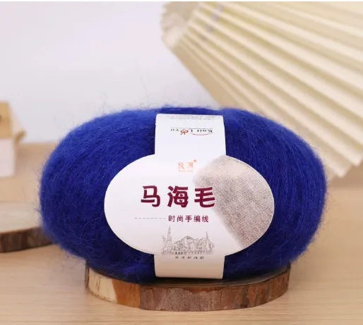 DIY mohair scarf weaving kit showing one wool ball and a selection of 34 colour options including white, pink, blue and green.