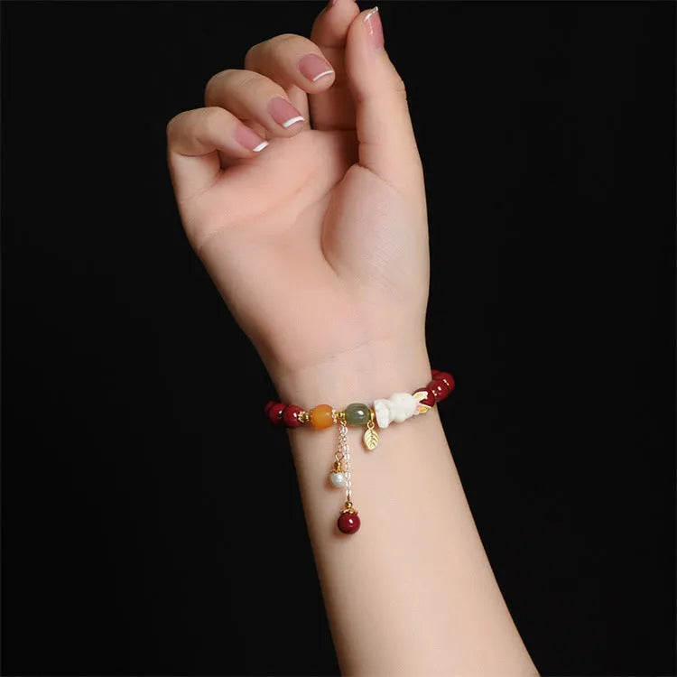 Natural beeswax purple gold sand bracelet with a detailed hand-carved cinnabar rabbit charm.
