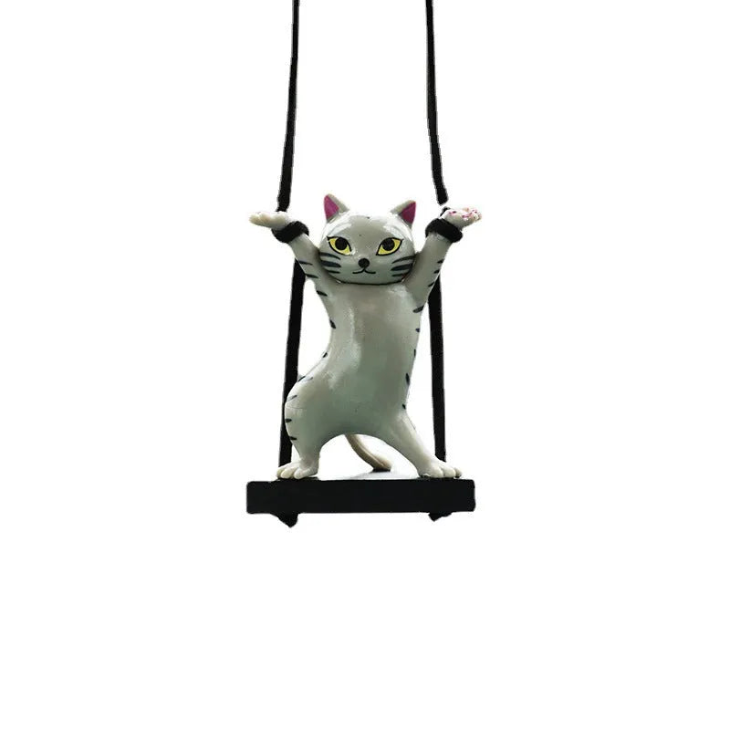 Cartoon style resin cat pendant on a rope for hanging in a car, shown in multiple colour options.