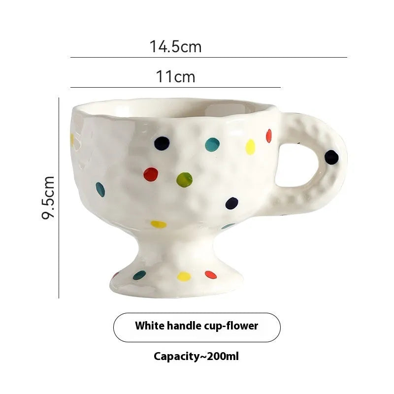 Hand-pinched irregular ceramic mug in a solid colour, showing unique handmade shape.