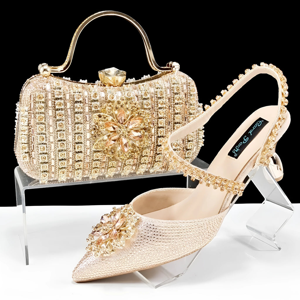 Women's black synthetic leather high heels with ankle chain and matching clutch bag with rhinestone flower decoration