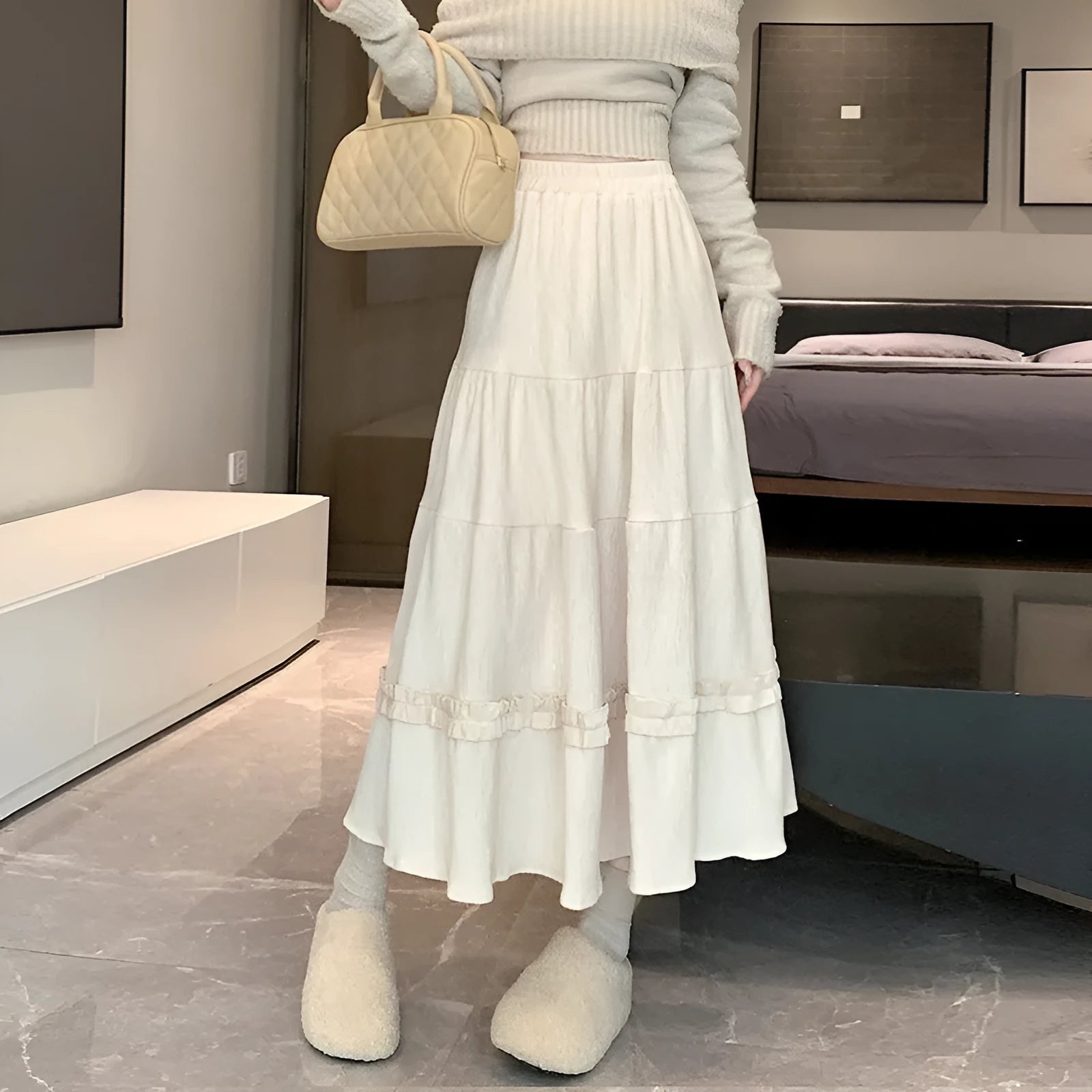 Women's solid colour corduroy A-line midi skirt with an elastic waistband shown in beige.