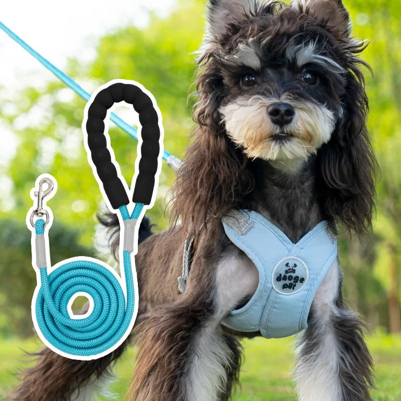 Blue polyester dog vest harness with an attached hand-held rope for walking.