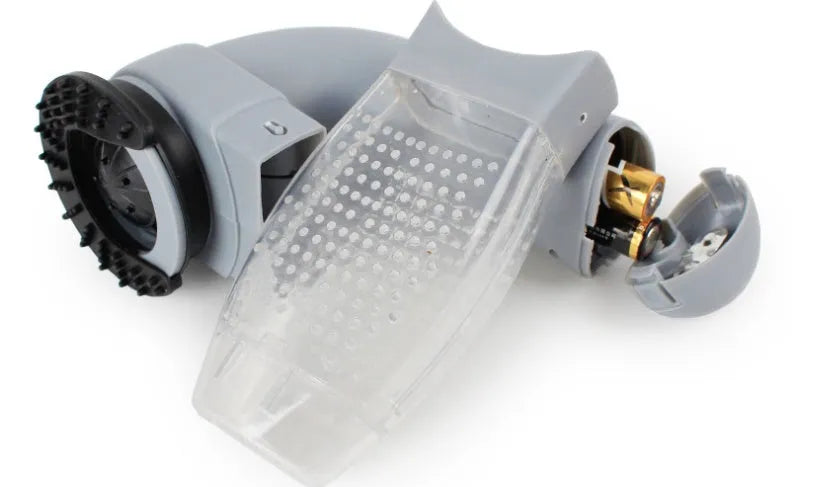 Gray portable electric pet hair remover with soft rubber head and collection canister.