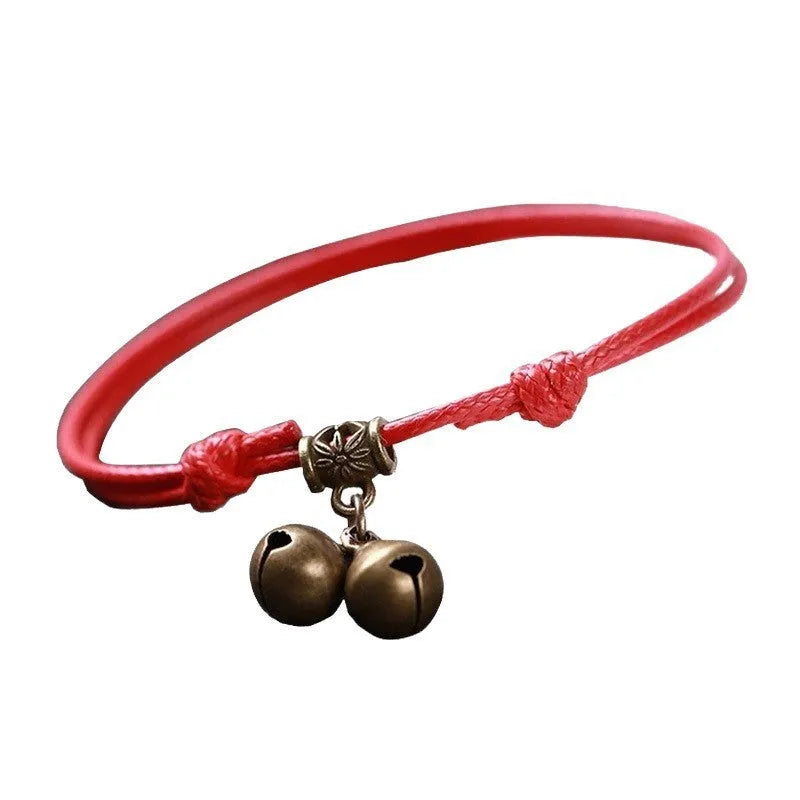 Small dog wearing adjustable nylon rope collar with brass bell in black, red or coffee colour