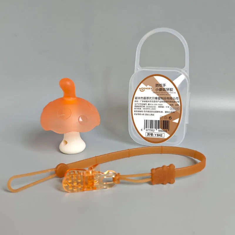 Small mushroom-shaped pink chewing gum inside a transparent box with a silver chain attached.