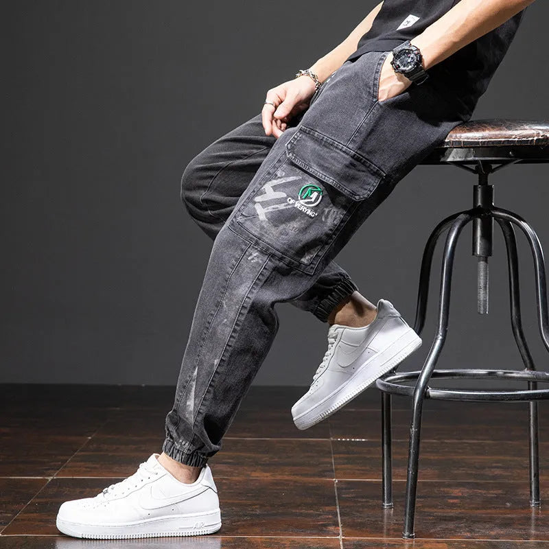 Men's loose-fit light blue cargo jeans with pockets and straight leg on a neutral background.
