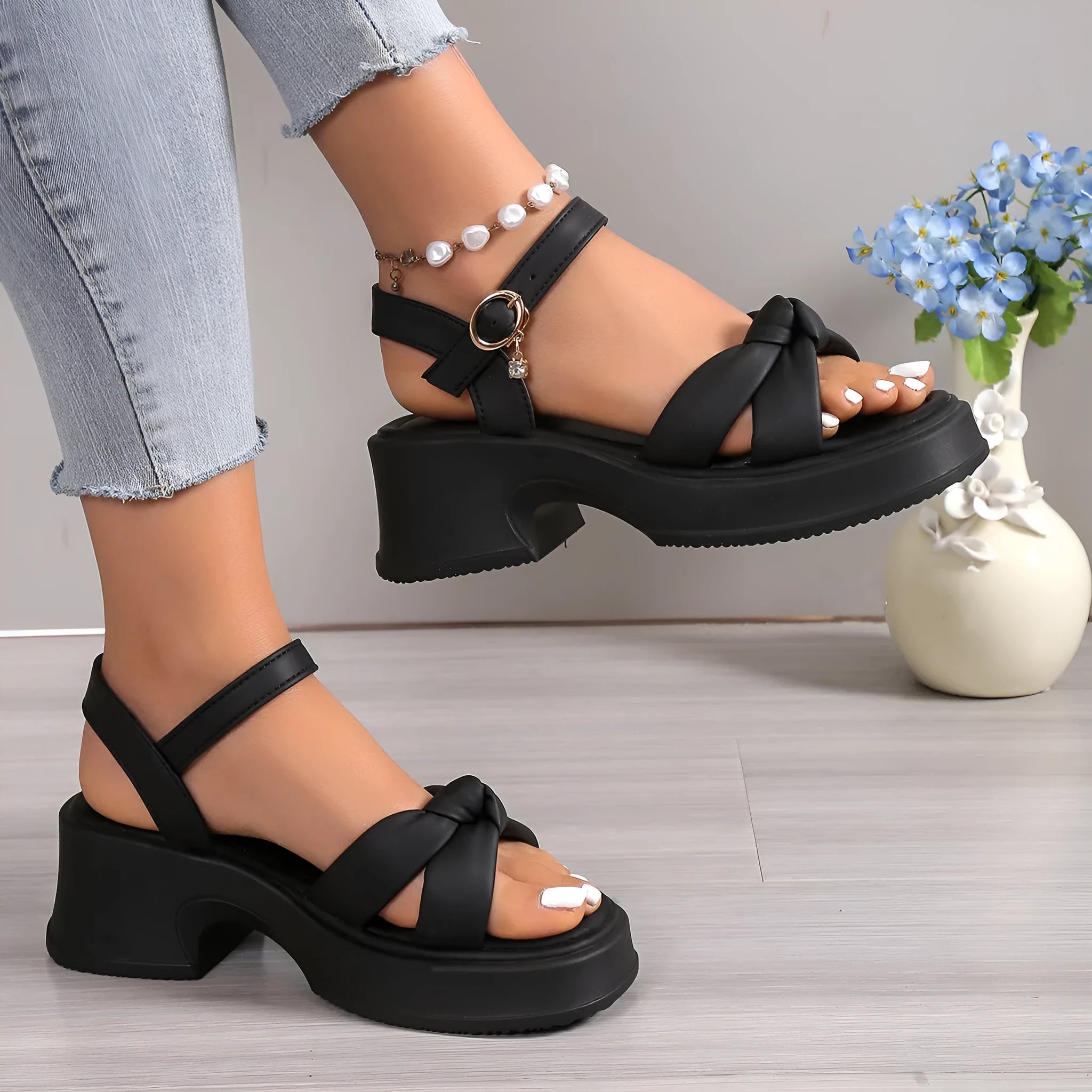 Black thick-heel high heel slippers with button closure and round toe design