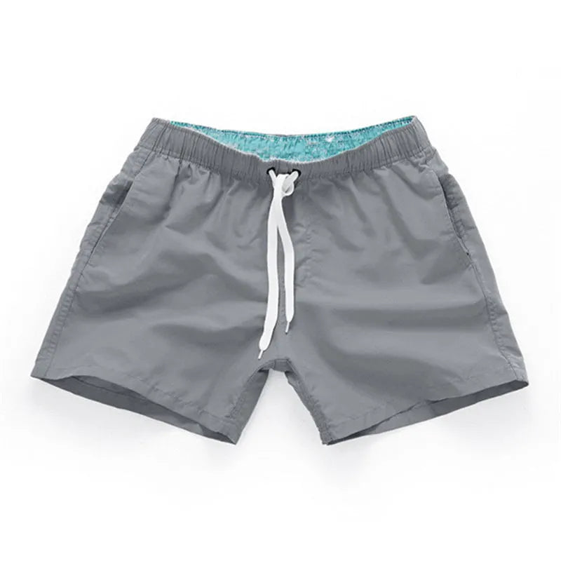 Men's straight-leg beach shorts in polyester fabric, shown in multiple colours and plus sizes.